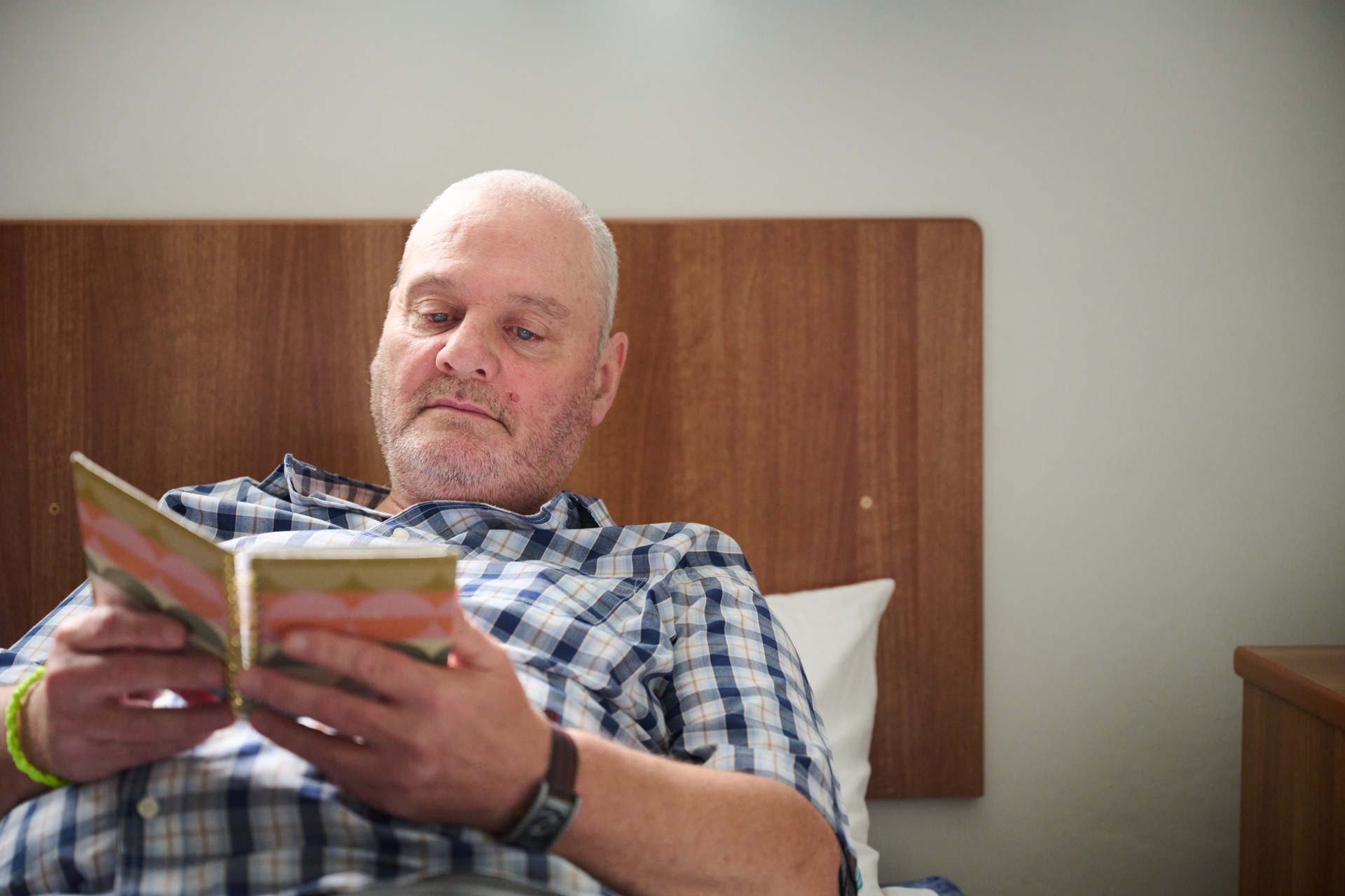 Resident relaxing on a bed at Clouds House